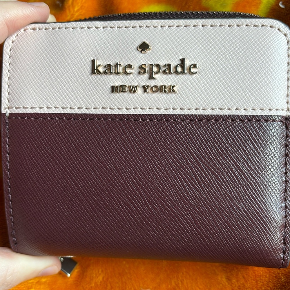 Compact zip-around wallet. Multiple card slots and interior compartments.
